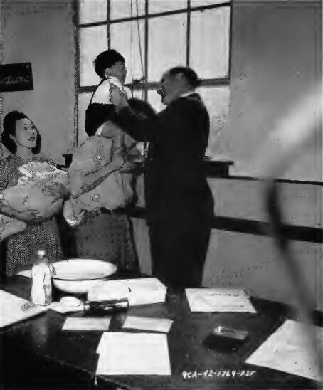 Preliminary medical examination of a family group at a Los Angeles control station