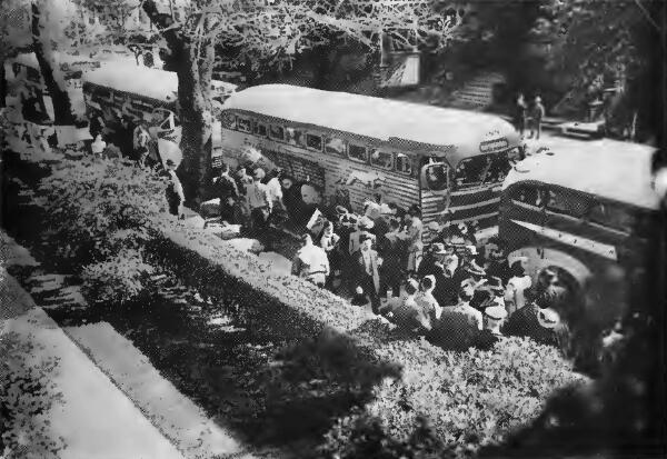 Evacuees loading baggage and boarding special busses at a Berkeley Control Station