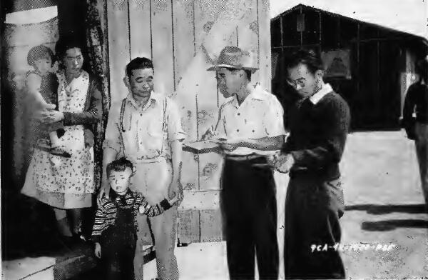 Head of a family of four being interviewed after arrival at Santa Anita (California) Assembly Center