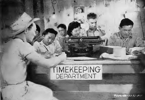 Scene in the timekeeping office at Stockton (California) Assembly Center