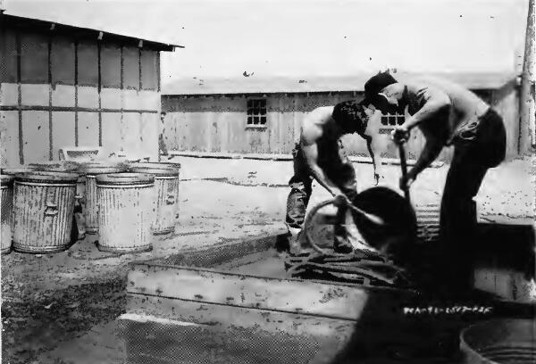 Evacuee workers giving garbage cans a daily washing, at Puyallup (Washington) Assembly Center