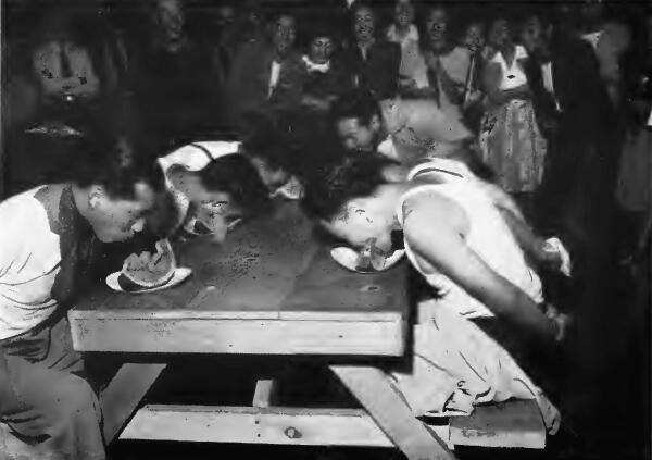 Evacuees in a watermelon eating contest at Santa Anita (California) Assembly Center