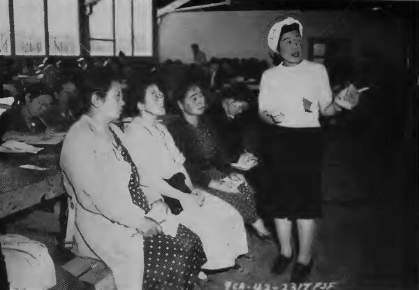 A Japanese teacher instructing a group of adult evacuees at Tanforan (California) Assembly Center