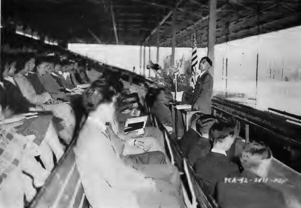 A Christian minister conducting services in the grandstand at Santa Anita (California) Assembly Center